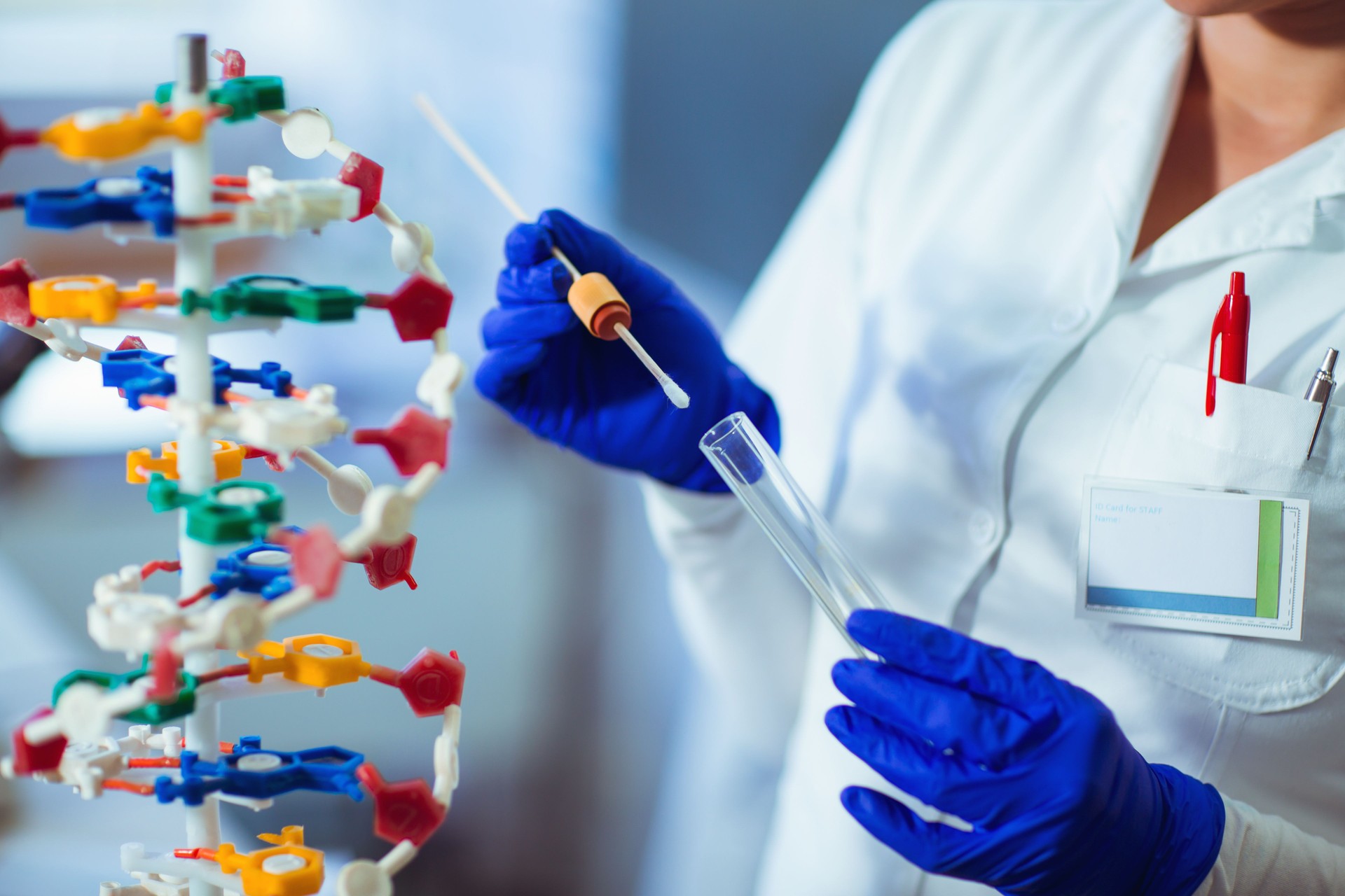 Female forensic technician collecting biological specimen in DNA