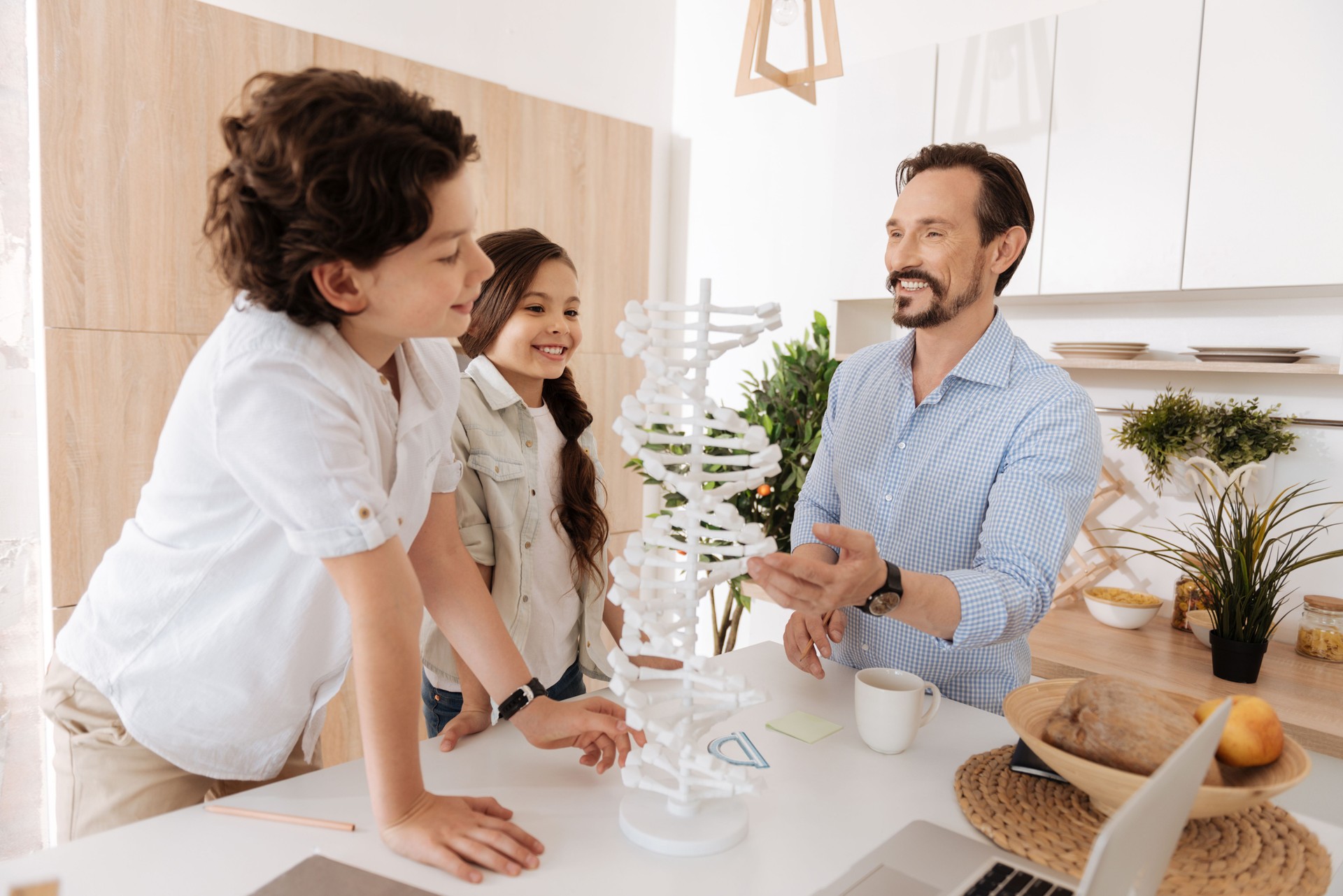 Father and his children studying DNA model